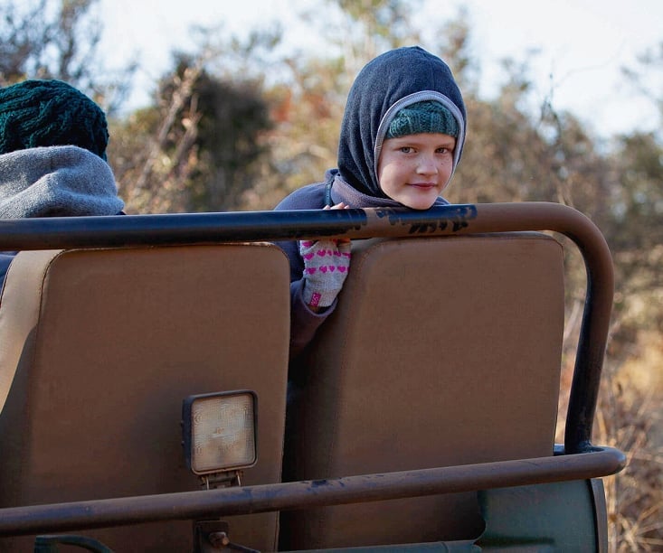 Family in game drive vehicle